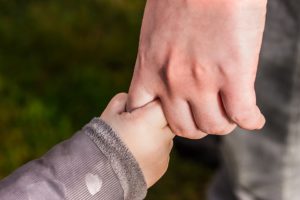 man holding child's hand