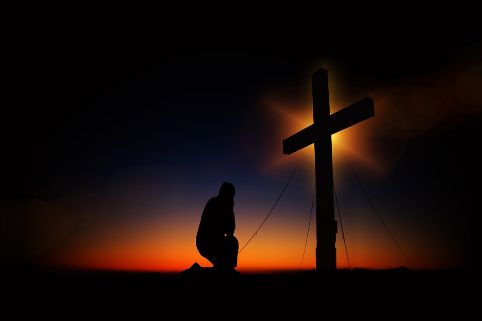 praying at the cross