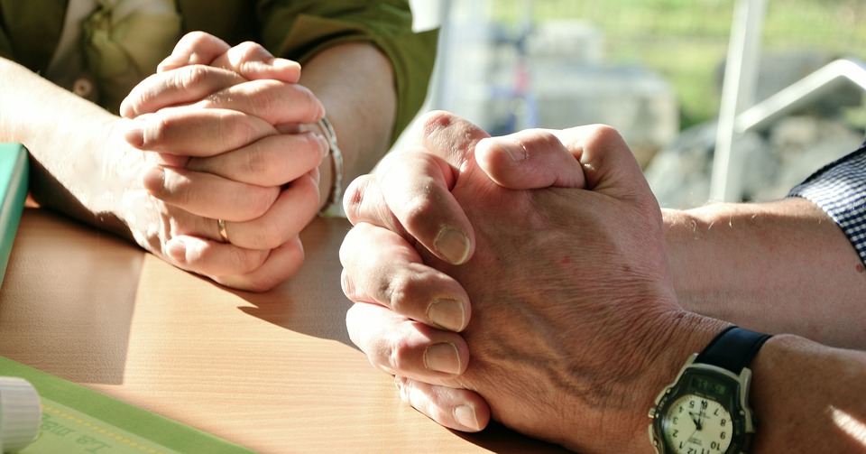 two people praying together