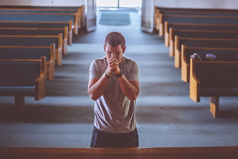 man praying at the alter