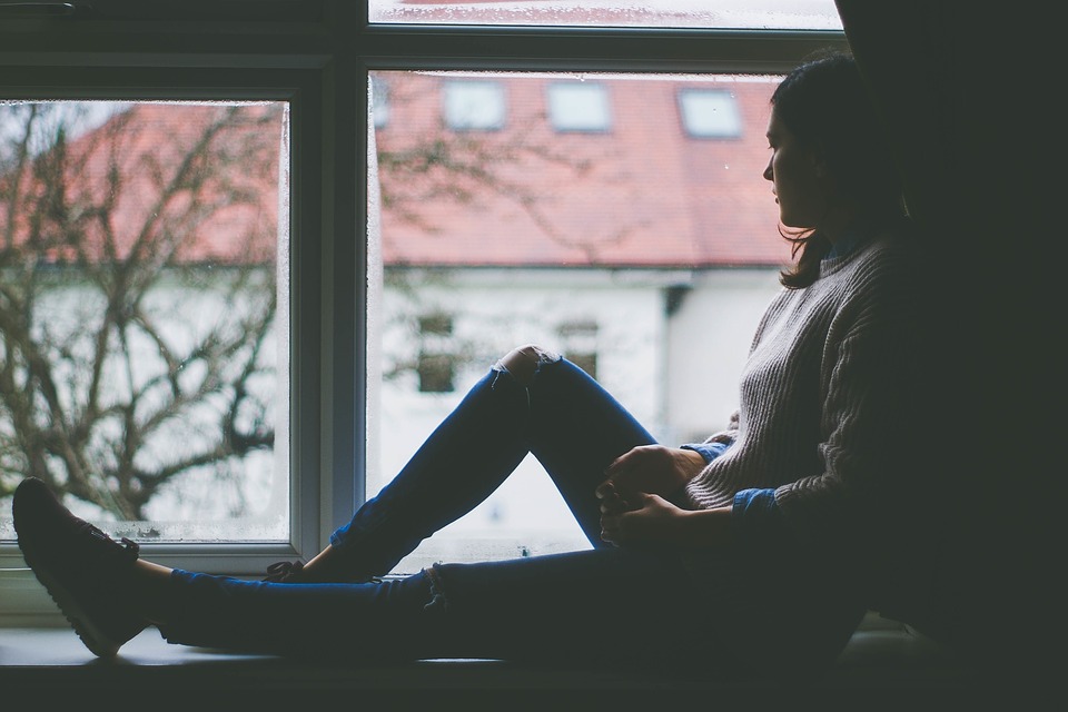 sad woman looking out window