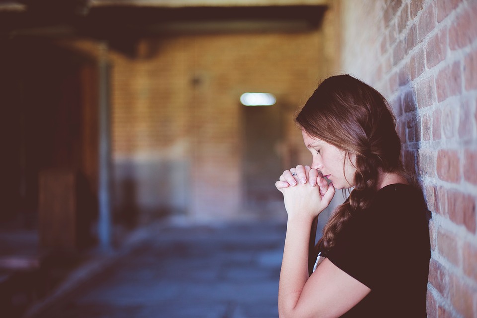 girl praying alone