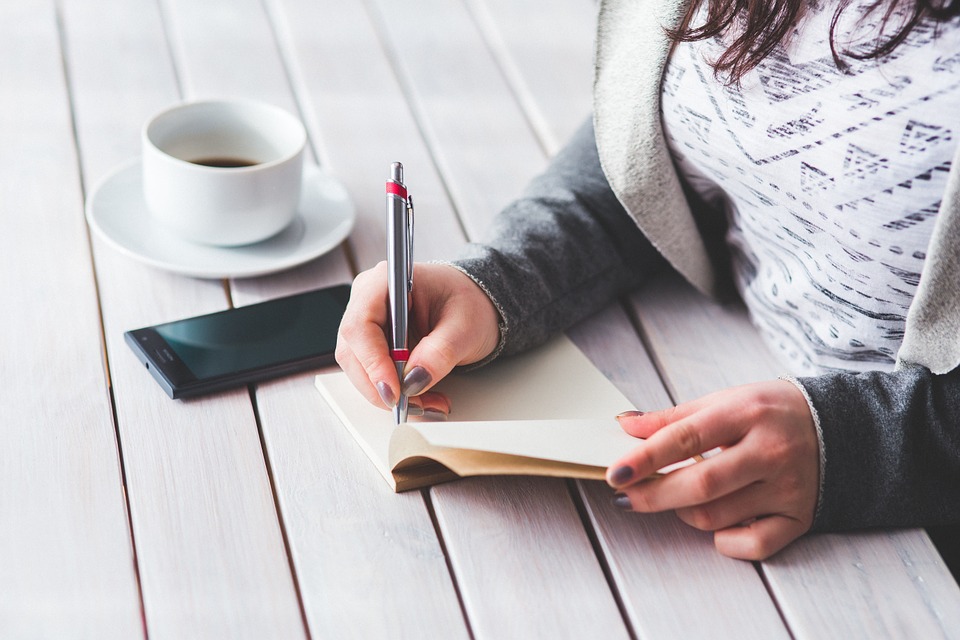 woman writing in notebook